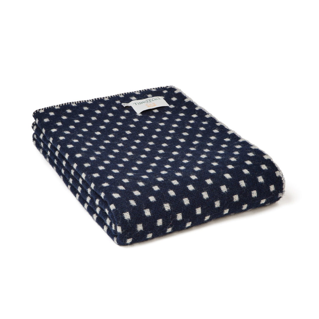 Tweedmill Navy Dot Wool Throw displayed folded with a navy and white patterned design, perfect for cozy living spaces.