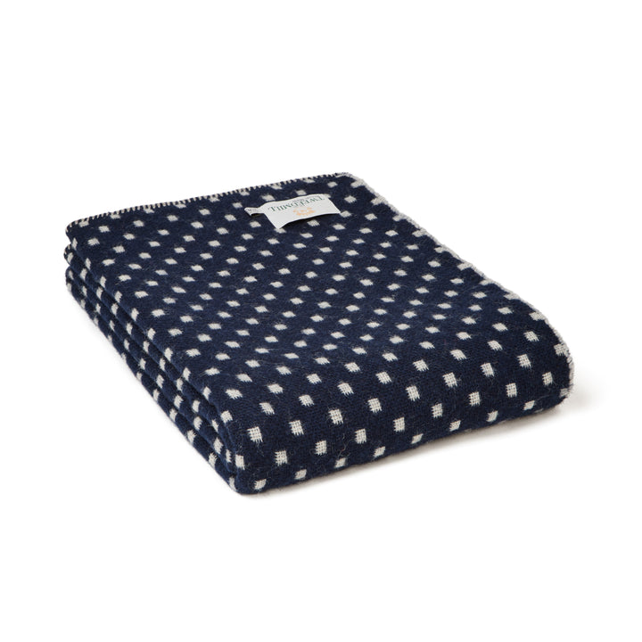 Tweedmill Navy Dot Wool Throw displayed folded with a navy and white patterned design, perfect for cozy living spaces.