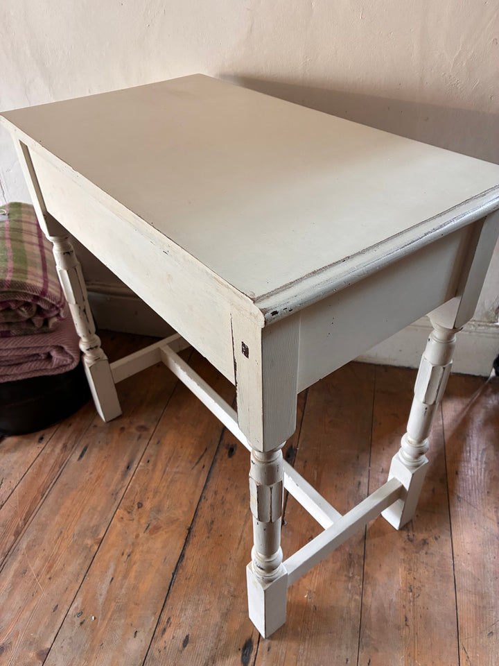 Vintage Painted Side Table with Drawer in off-white finish, featuring elegant turned legs and subtle distressing, Source for the Goose Devon.