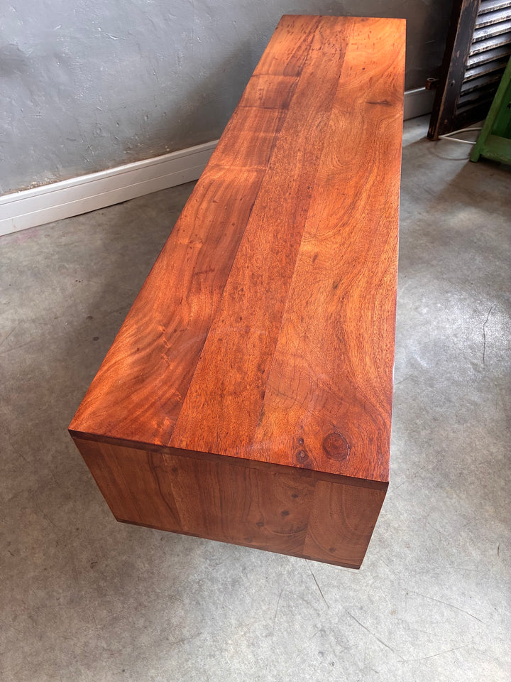 Minimalist Acacia wood TV stand showcasing rich grain and smooth finish, perfect for contemporary living spaces.