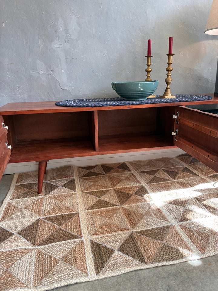 Retro Swoon Editions TV Stand with mid-century design, featuring wood doors and decorative bowl, styled in a cozy living space.