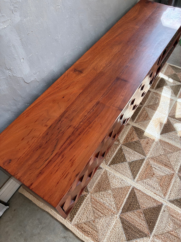 Top view of the Retro Swoon Editions TV Stand showcasing its rich Acacia wood grain and unique tessellated door design.