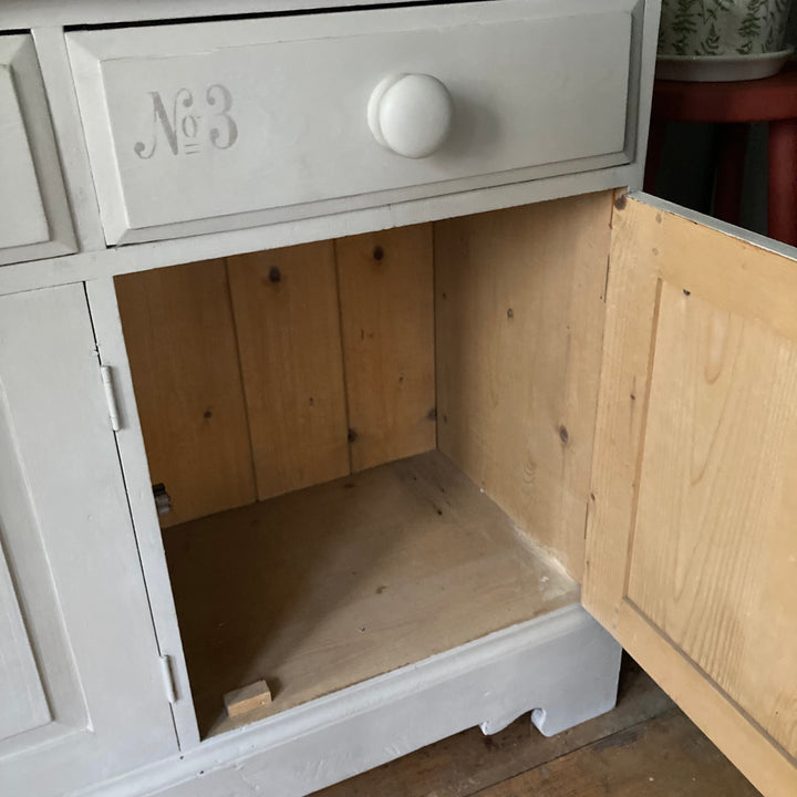 interior of three wide cupboard on painted dresser