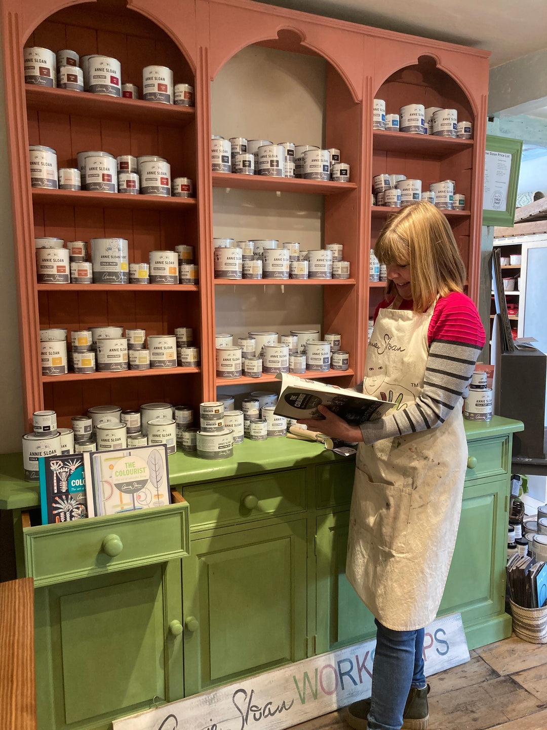 Jill, owner of Source for the Goose in front of her Annie Sloan Chalk Paint display