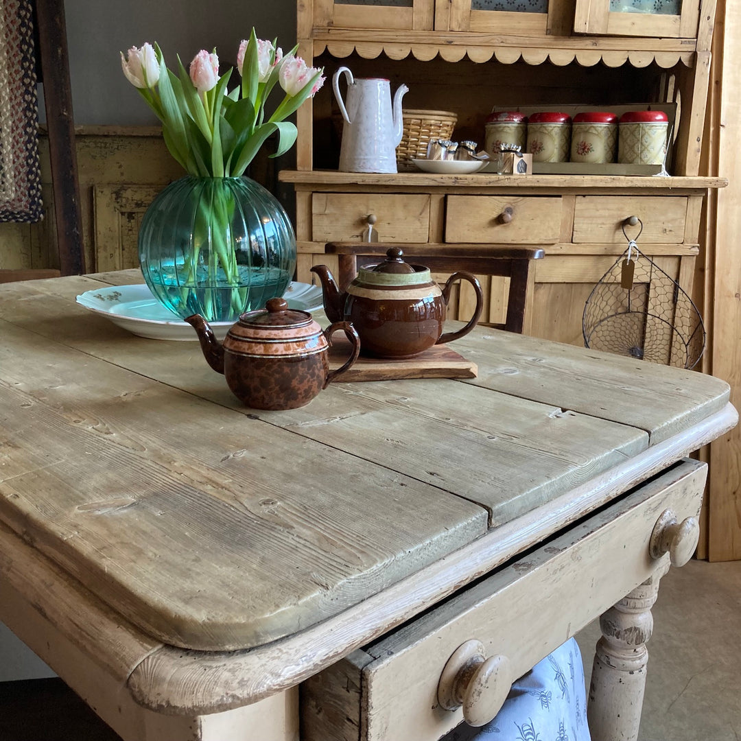 Vintage brown Betty teapots on a scrub top table