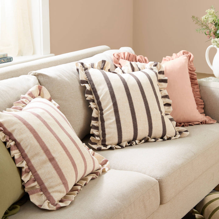 Square Striped Ruffle Cushion Clay Pink - Connie on a cozy sofa, showcasing vintage charm and cottage-core style.