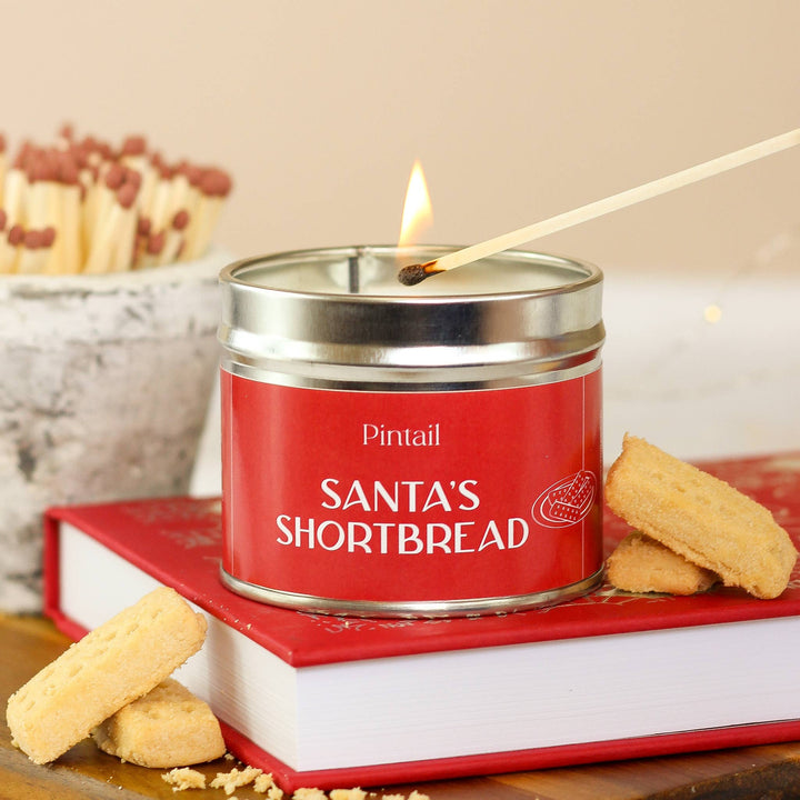 Pintail Santa's Shortbread Classic Tin Candle with sweet, festive aroma, lemon zest, buttery biscuits, and winter spices on a cozy table setting