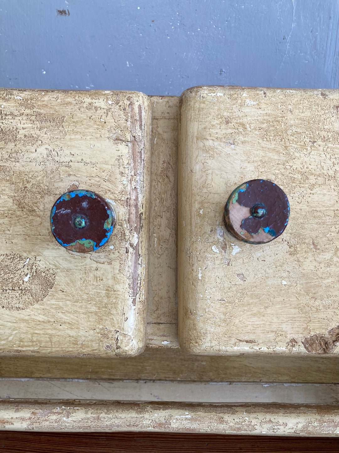 Close-up of the vintage knobs on a 1930s wooden wall cupboard with a unique scumble painted finish from Source for the Goose, Devon.