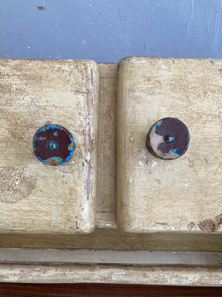 Close-up of the vintage knobs on a 1930s wooden wall cupboard with a unique scumble painted finish from Source for the Goose, Devon.