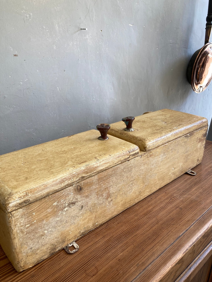 Vintage wooden box with two metal handles, featuring a rustic finish, perfect for home decor and organization.
