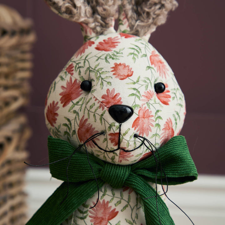 Hattie Hare Door Stop - Floral Design with handpainted floral patterns and a green bow, perfect for home decor.