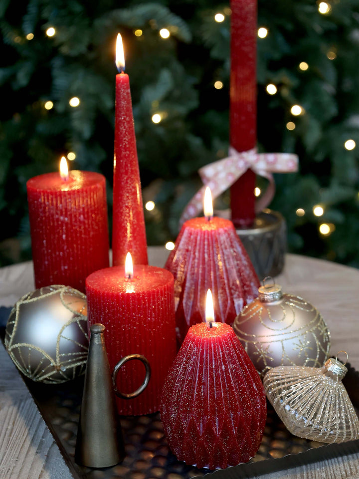 a selection of red candles in a Christmas display