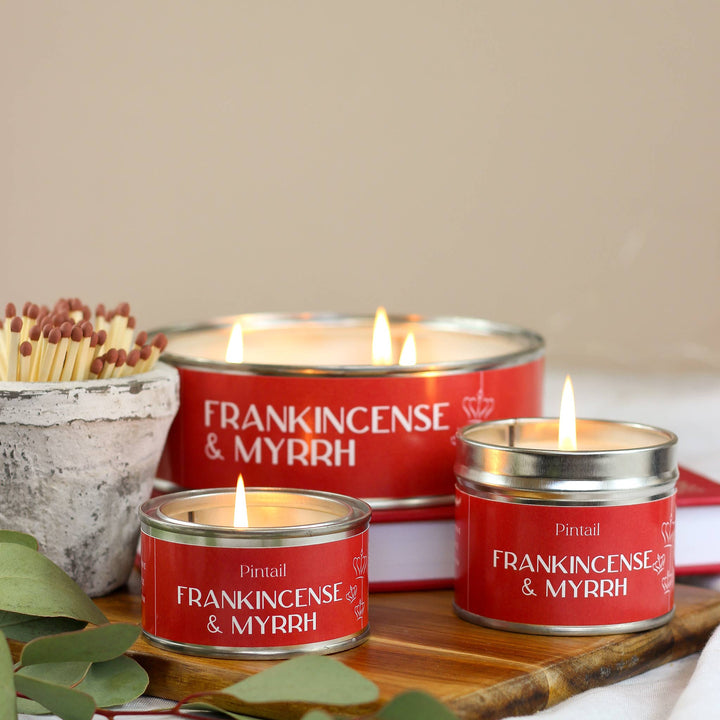 Pintail Candles Frankincense & Myrrh Classic Tin Candle, creating a cozy atmosphere for the holidays.