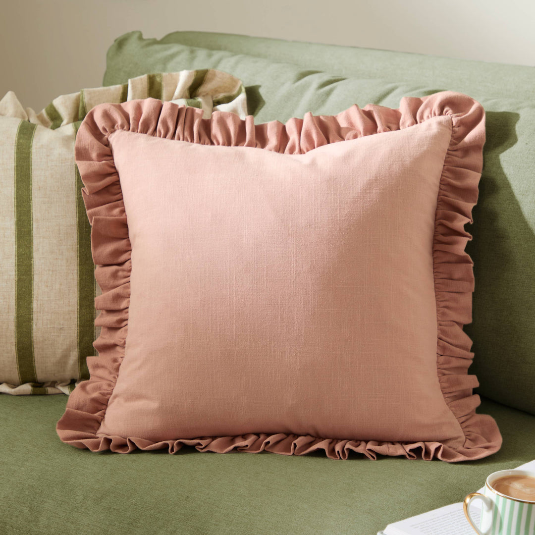 Vintage Blush Rose Ruffle Cushion - Effie accentuating a cozy living space with its elegant design.