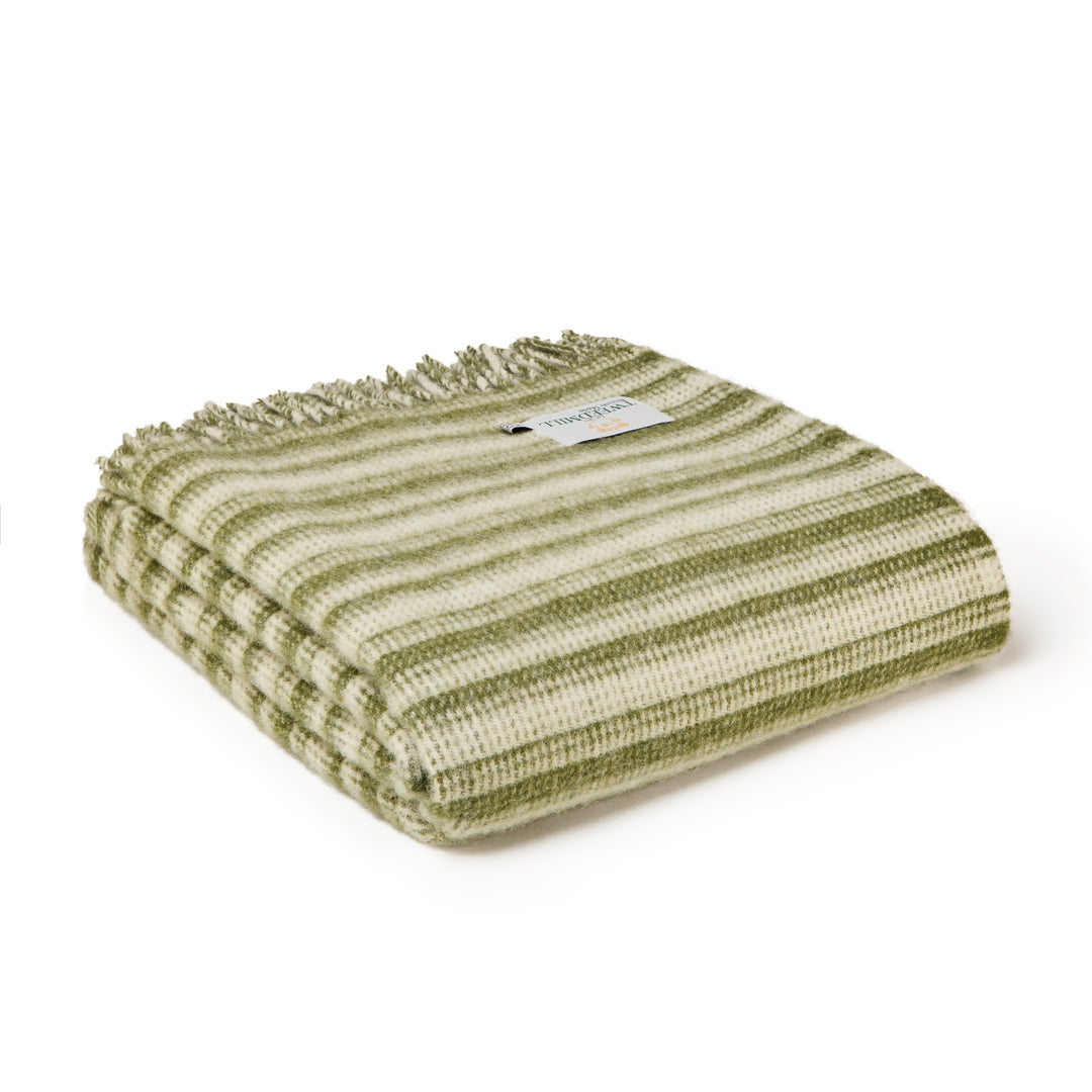 Tweedmill Olive Green Aber Stripe Wool Blanket folded with soft green and cream stripes and tassels, perfect for cozy comfort.