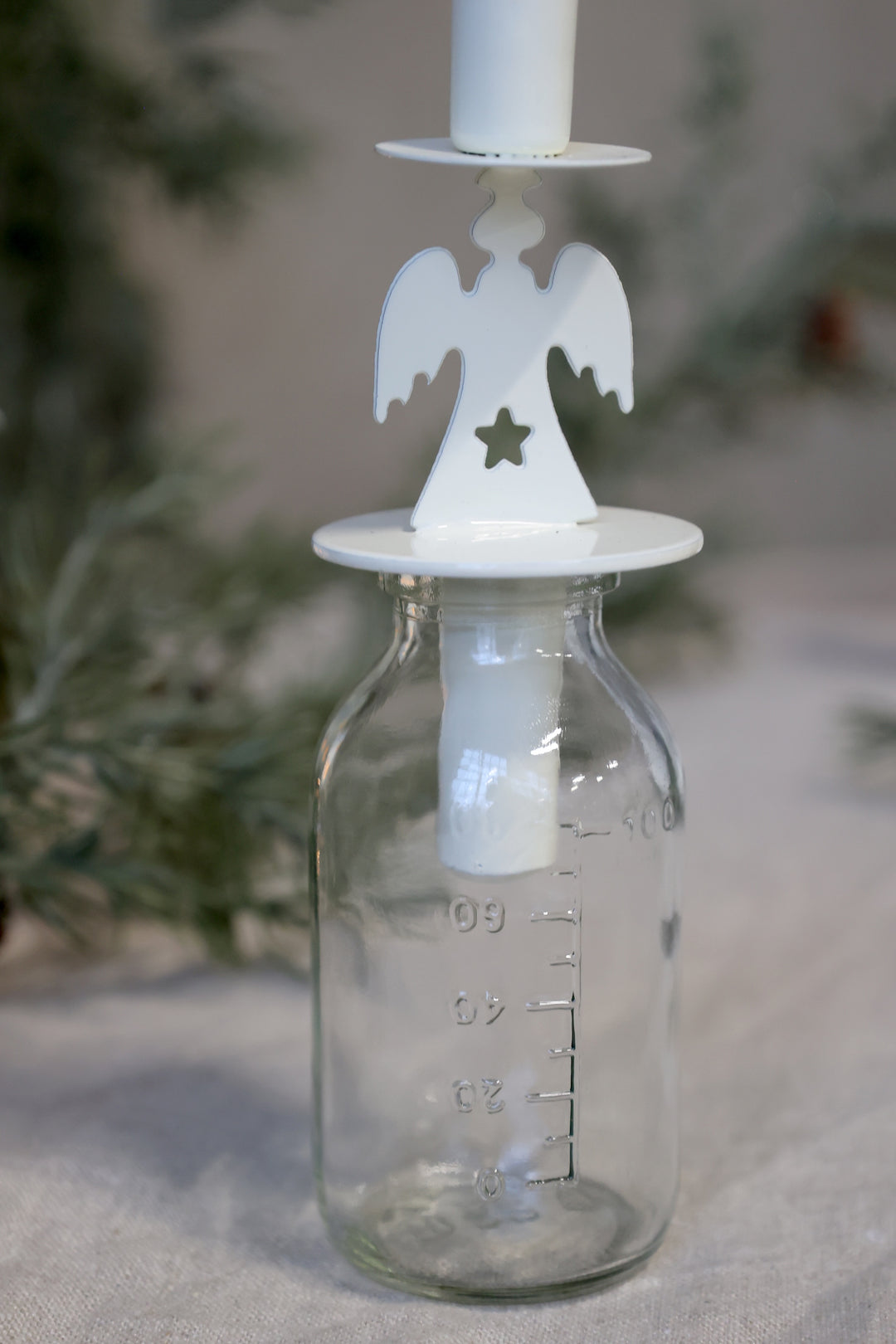 Angel Design Bottle Candle Holder from Source for the Goose Devon, featuring a delicate angel atop a glass base.