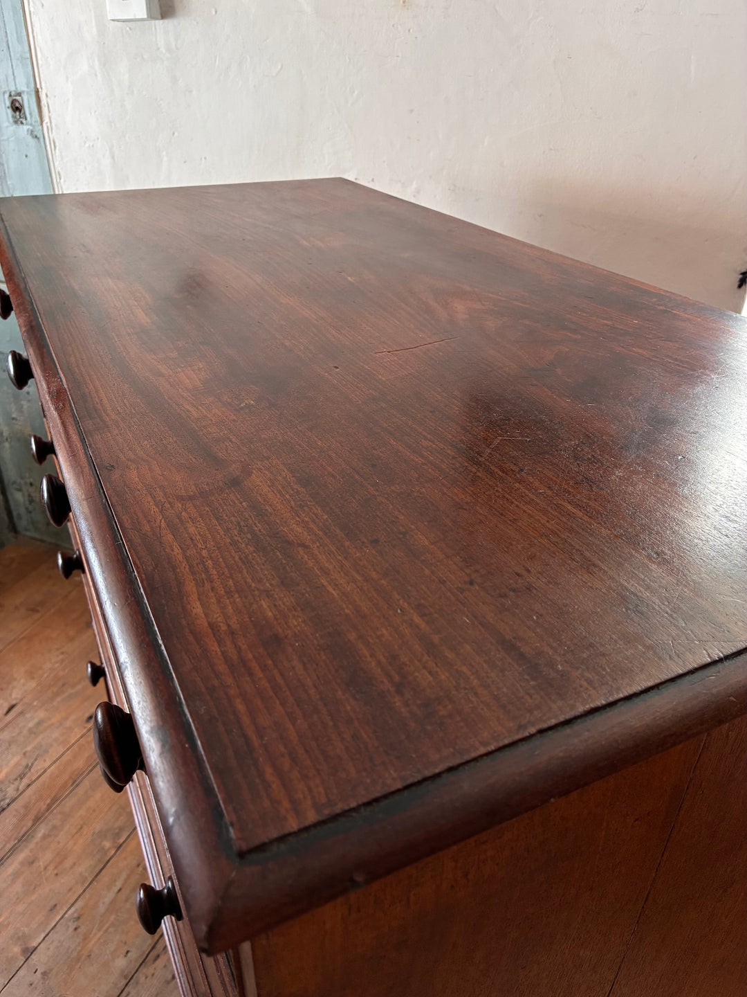 Tall Antique Mahogany Chest of Drawers top view showcasing craftsmanship and rich mahogany wood texture.
