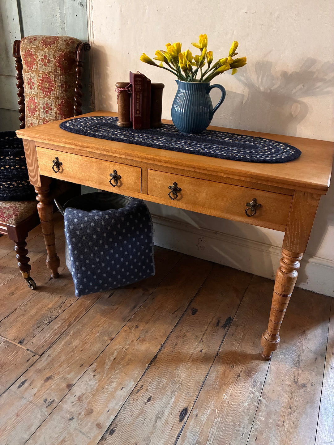 Low Antique Console Table with yellow flowers, books, and decorative cloth on top, showcasing golden ash wood.
