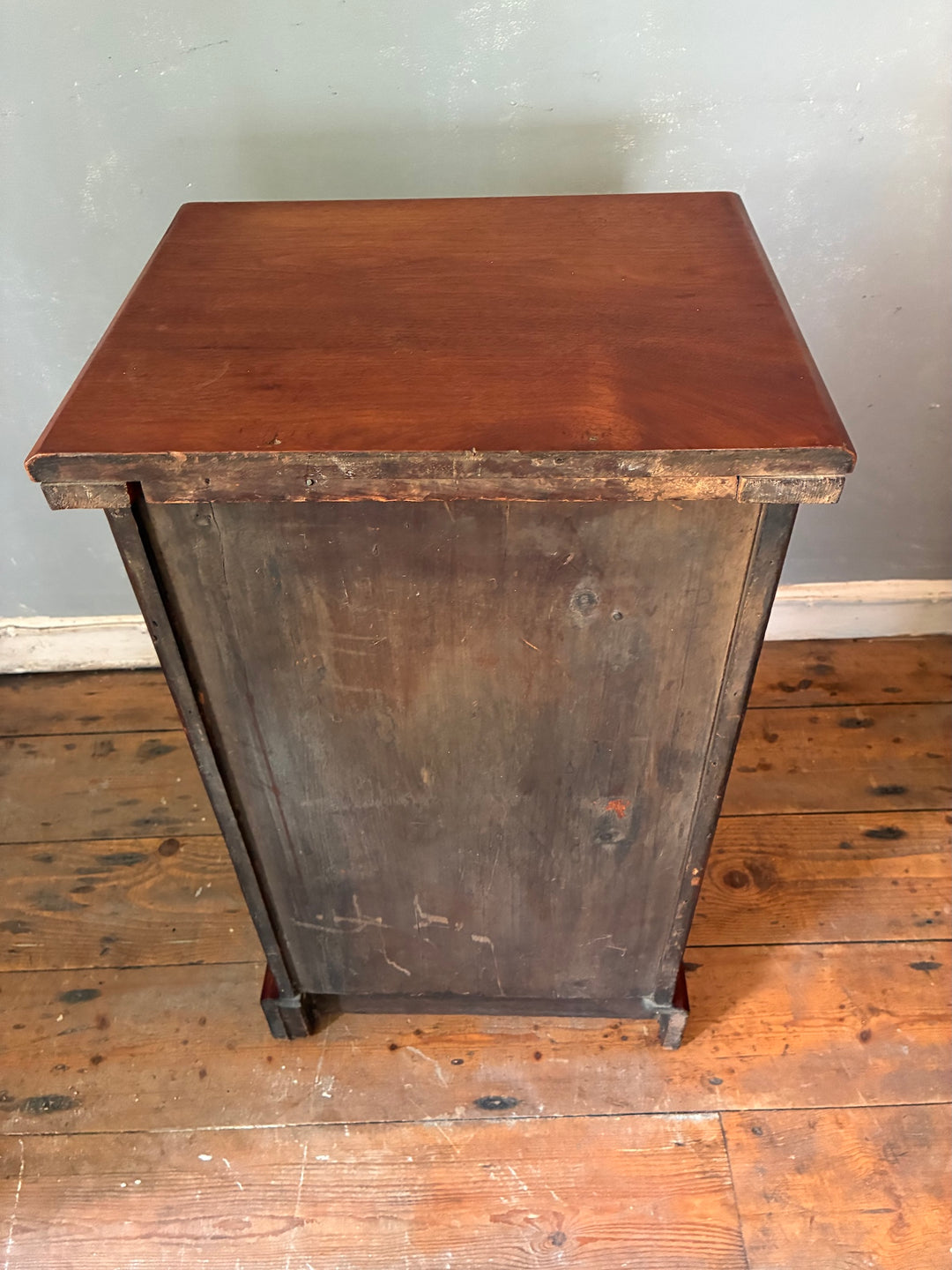 Antique Mahogany Bedside Cabinet with single panel door on wooden floor, enhancing traditional interior decor.