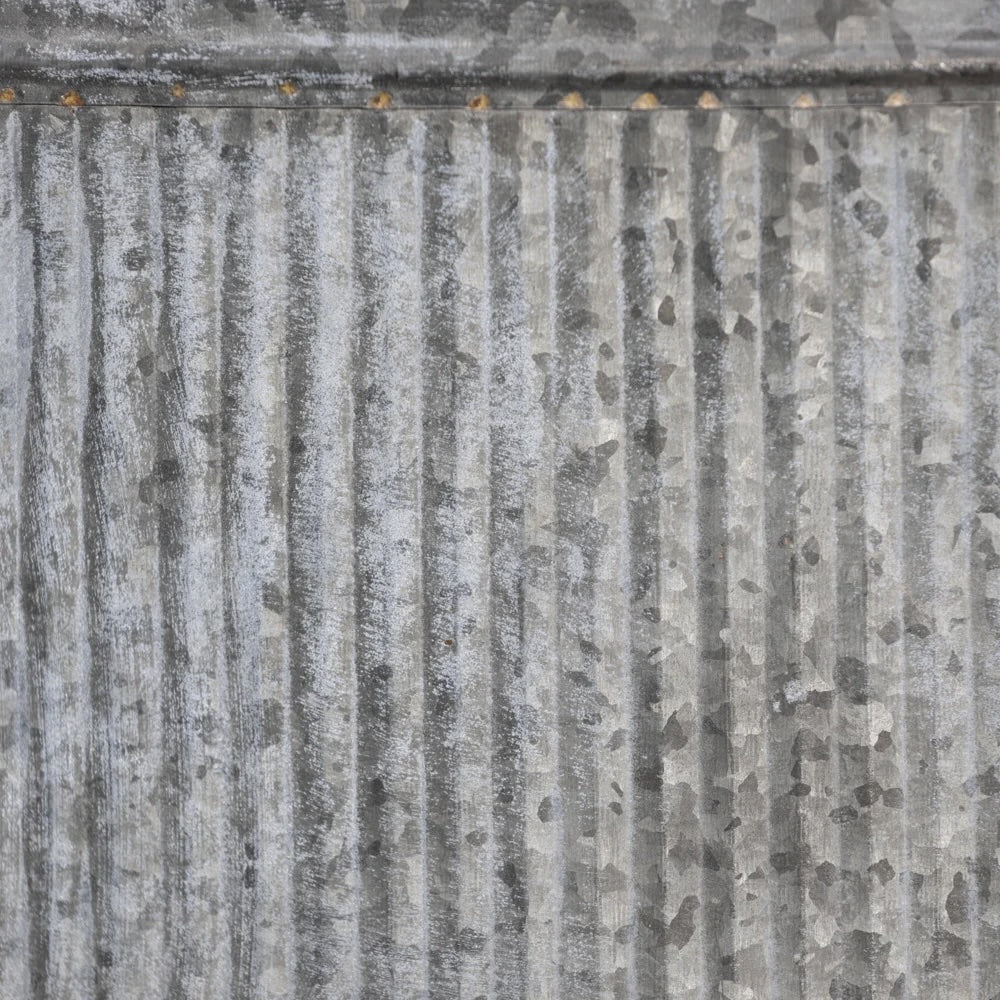 Close-up of the textured surface of an Oval Ribbed Zinc Planter with a rustic galvanized finish from Source for the Goose, Devon.