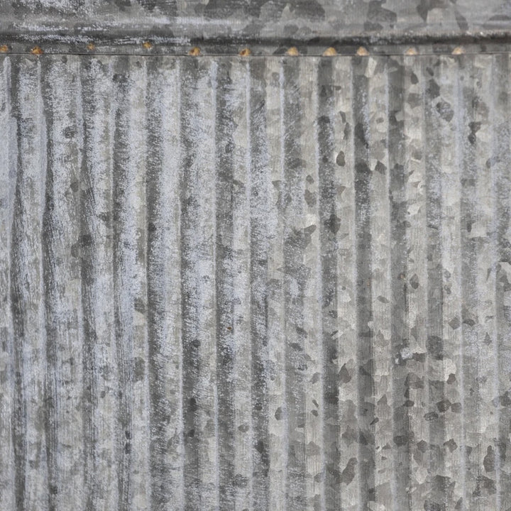 Close-up of the textured surface of an Oval Ribbed Zinc Planter with a rustic galvanized finish from Source for the Goose, Devon.