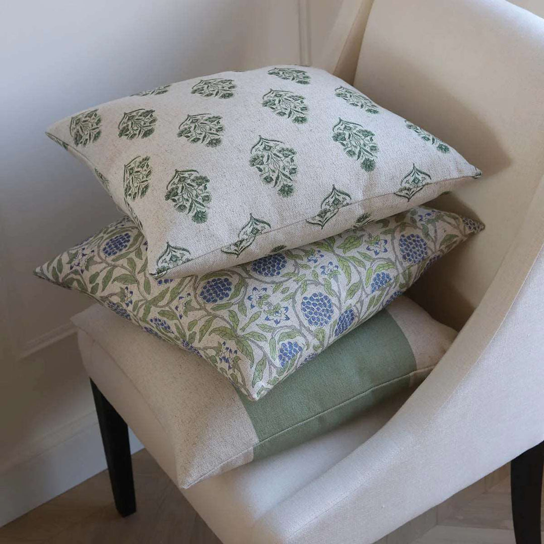 selection of blue and green linen mix cushions on a chair