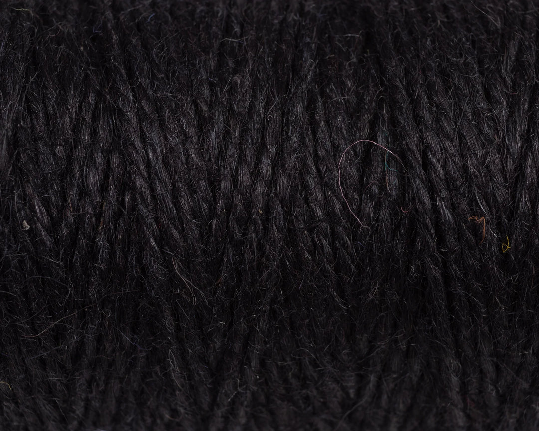 Nutscene Jute Twine on Hanging Recycled Lancashire Mill Bobbin close-up showing rich black color and texture.