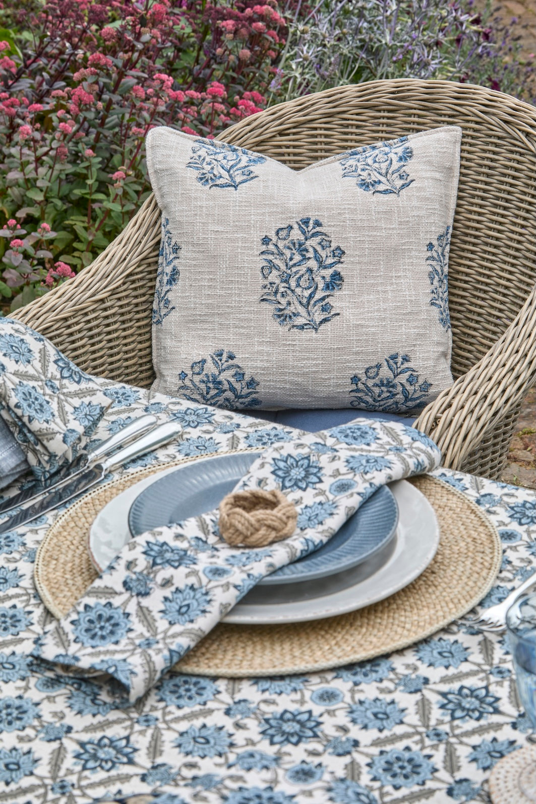 Hand Block Print Cushion in Ink Blue - Blickling on a beautifully set table with floral decor.
