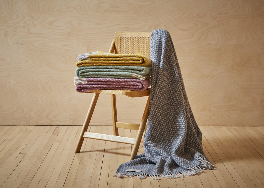 a display of blankets including a Blue Slate Diamond design by Tweedmill