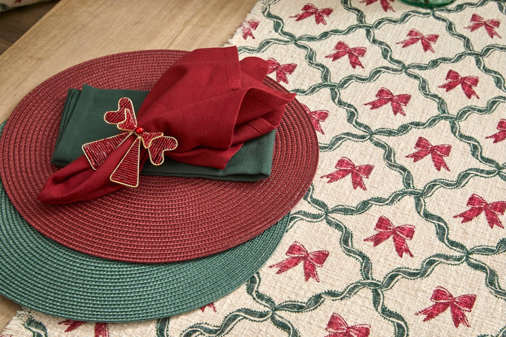 Woven Soft Green Circular Placemat with red napkin and decorative bow on a festive table setting.