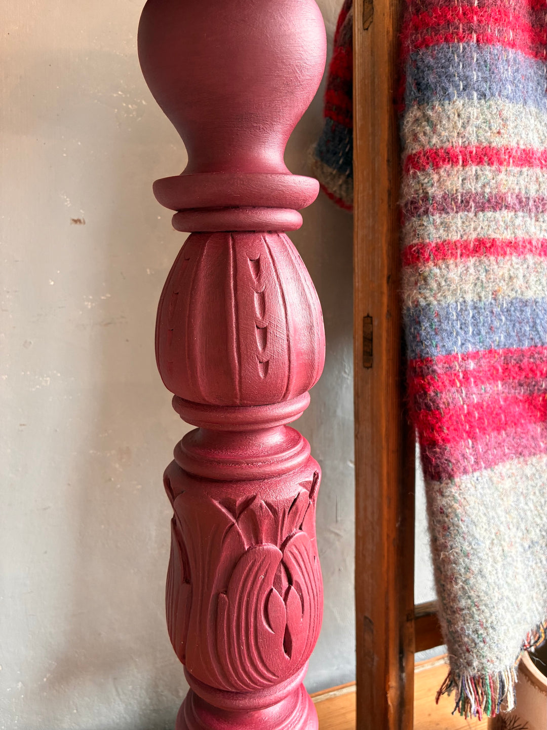 Close-up of the intricately carved design on the Vintage Wooden Burgundy Plant Stand by Source for the Goose Devon.