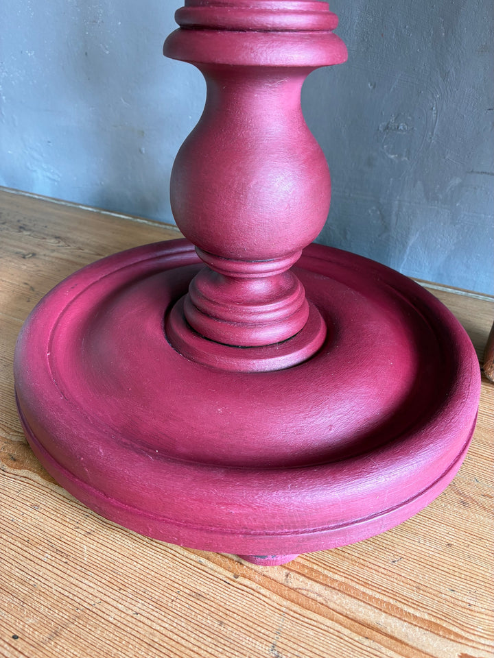 Close-up of the base of a Vintage Wooden Burgundy Plant Stand, highlighting its hand-painted finish and carved details.