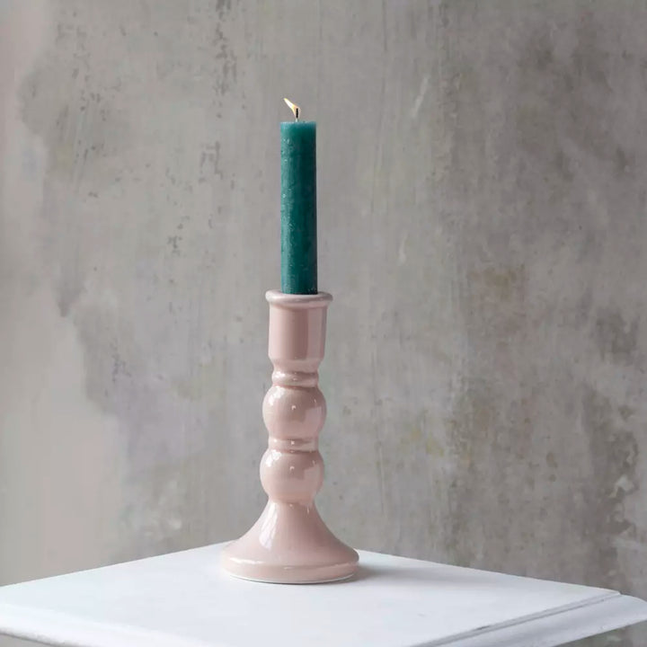 Blush Pink Crackled Glaze Candle Holder with teal candle on white table surface.