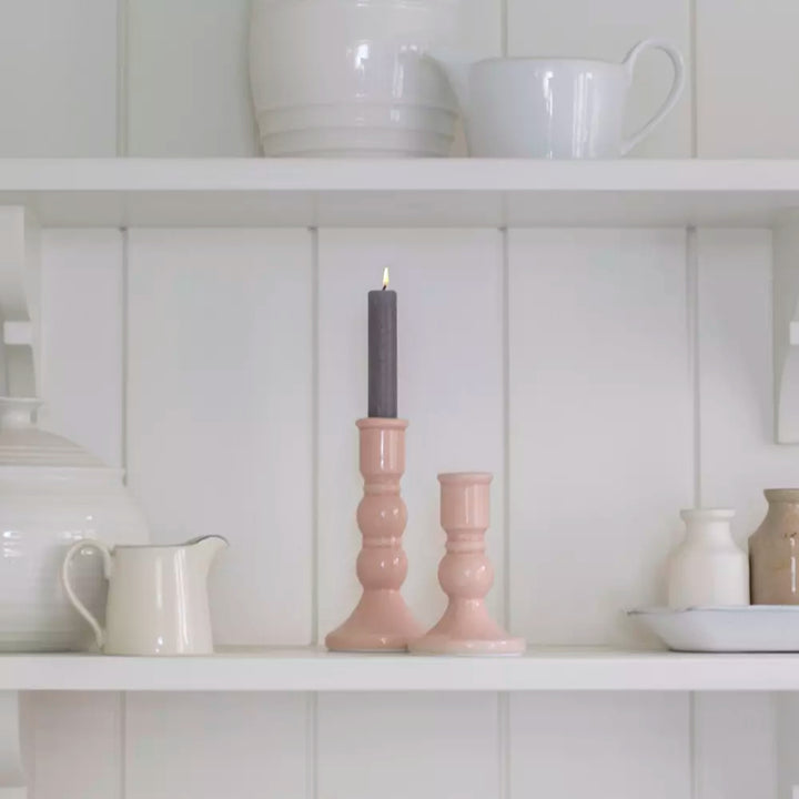 Blush Pink Crackled Glaze Candle Holder with a candle, displayed elegantly on a white shelf among ceramic decor.