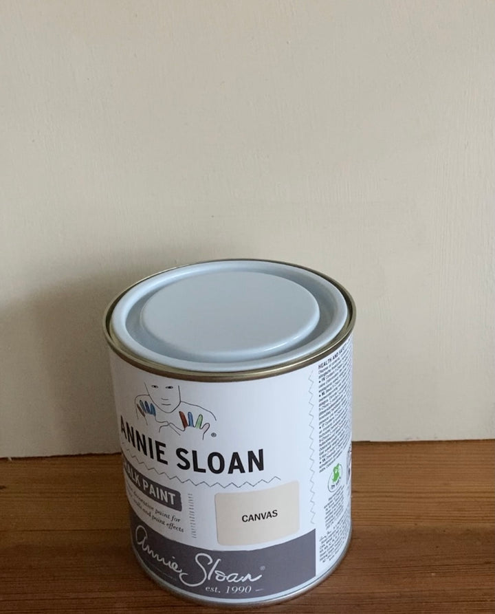 500ml Annie Sloan Canvas Chalk Paint can on wooden surface, showcasing its neutral tones for versatile decor.