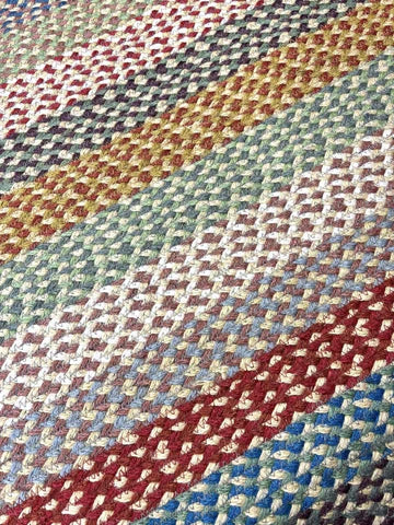 Close-up of a multicolored woven fabric with red, blue, and beige patterns.