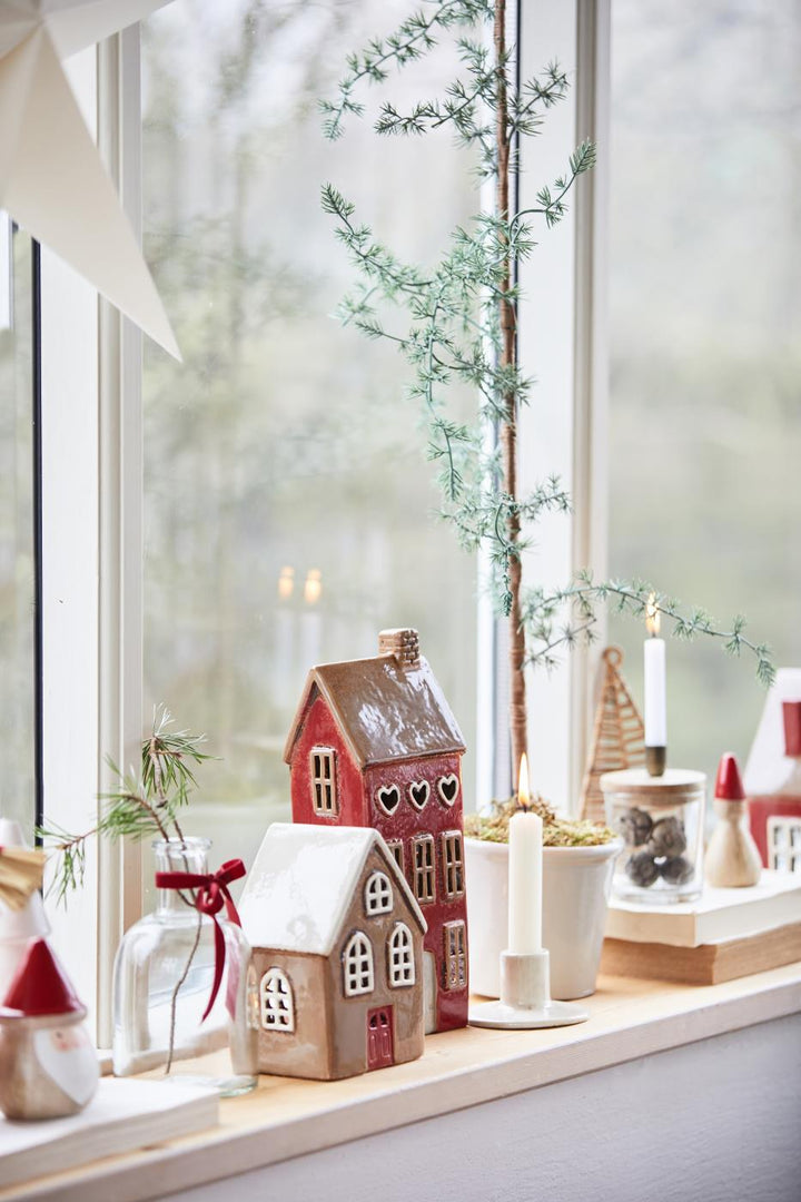 a display of ceramic christmas houses for tea lights