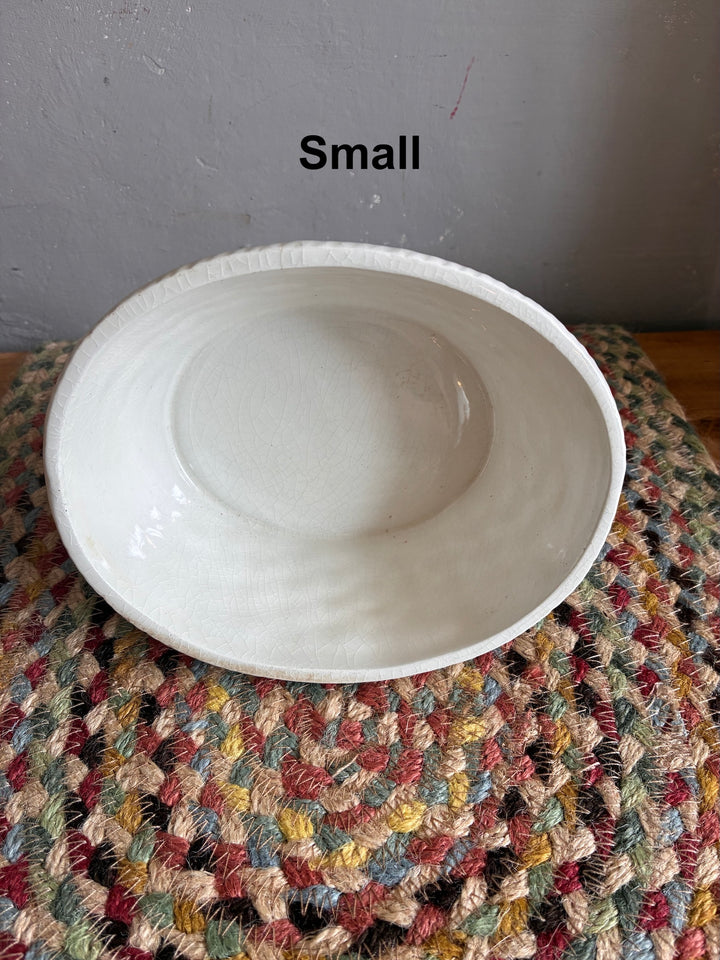Small ceramic bowl on a colorful textured mat, perfect for decorative use or serving.