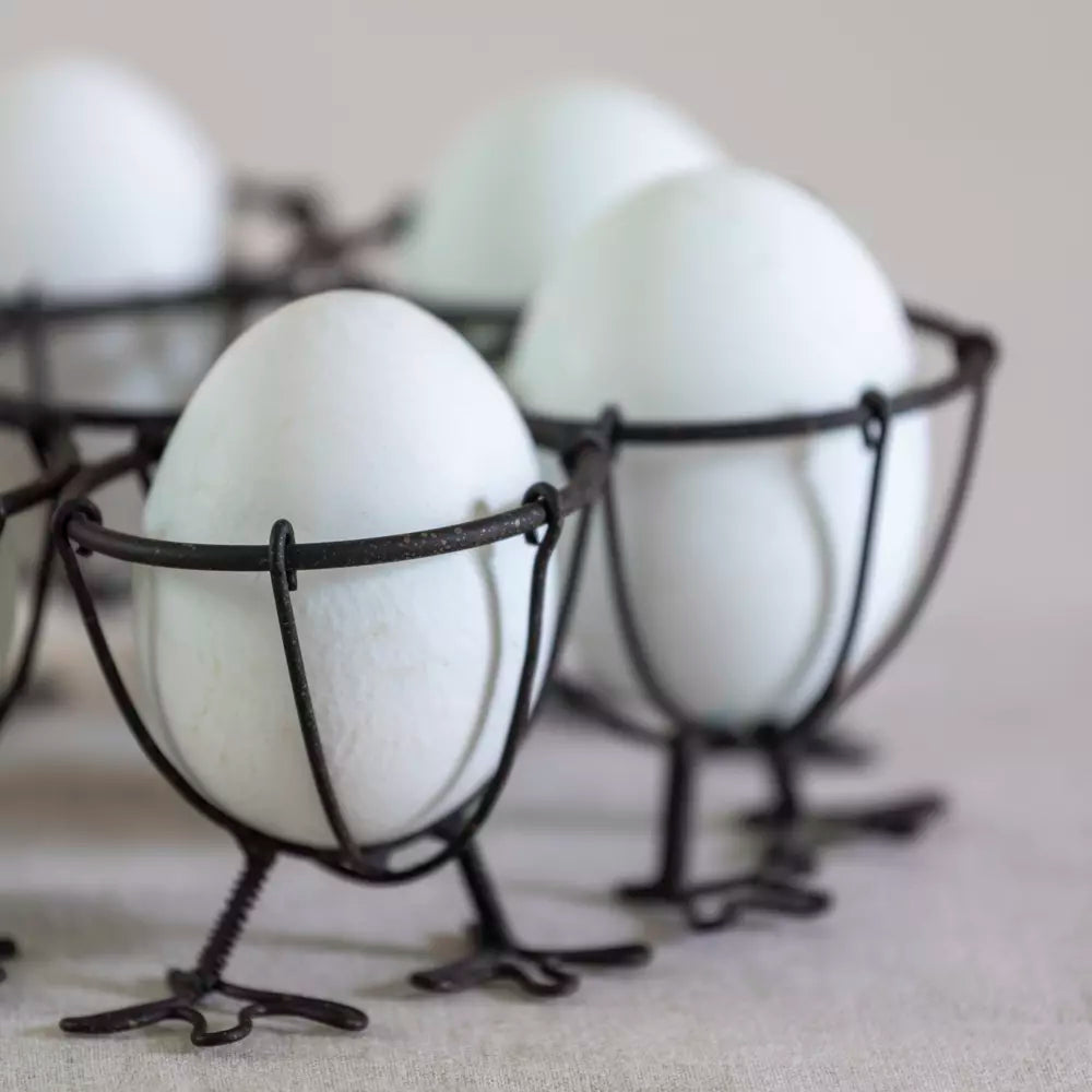Chicken Feet Wire Egg Holder with white eggs in a vintage-style metal rack for farmhouse kitchen decor.