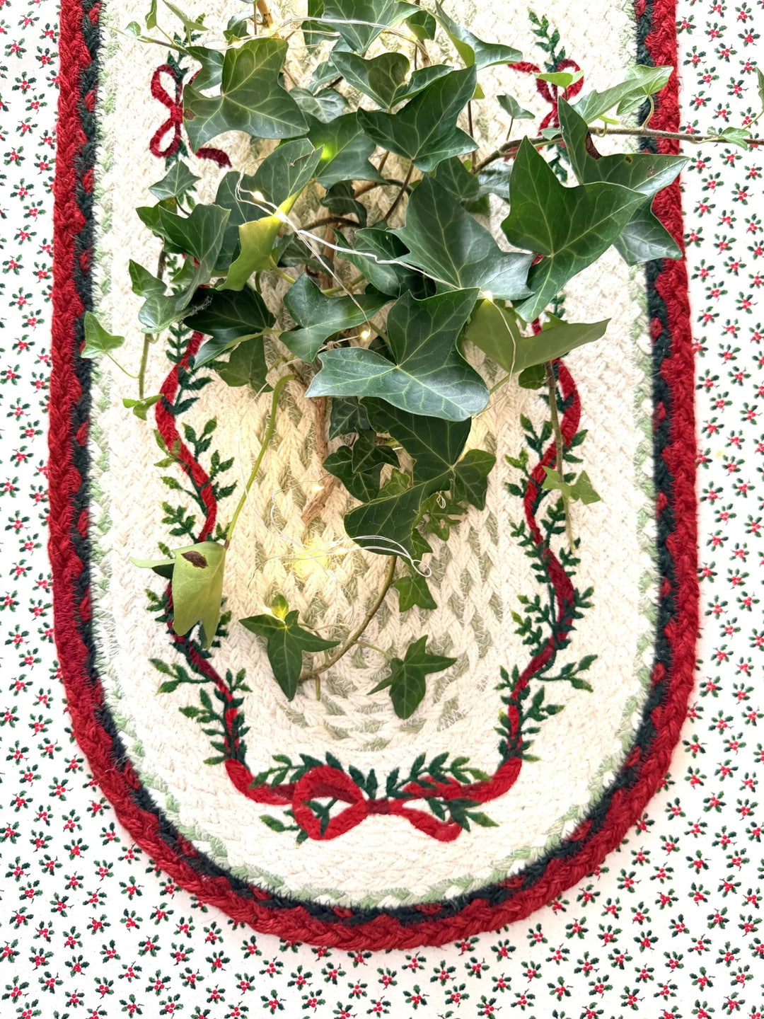 Christmas Ribbon Jute Table Runner- Christmas Tableware with festive greenery and red bow design on the table.