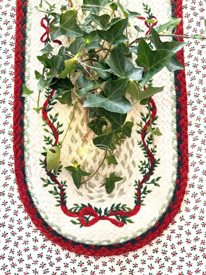 Christmas Ribbon Jute Table Runner- Christmas Tableware with festive greenery and red bow design on the table.