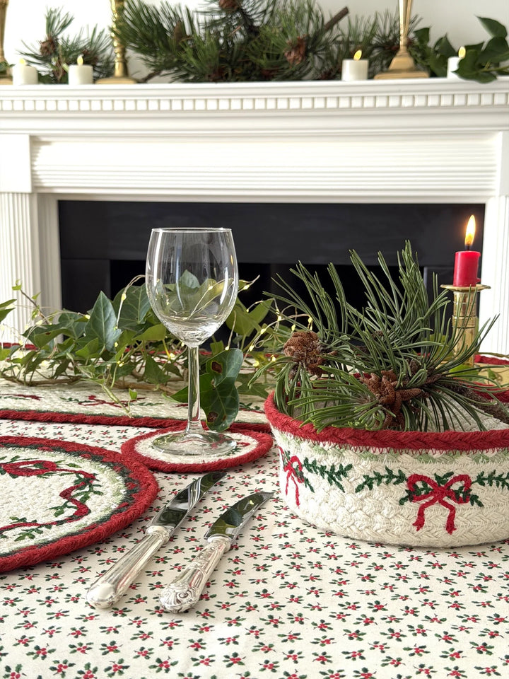 Set of Six Christmas Ribbon Round Jute Placemats - 30cm displayed elegantly on a festive dining table with decorative items.