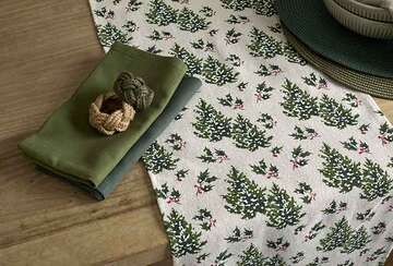 Snowy Trees Long Table Runner with green napkins, featuring a festive winter tree design for holiday gatherings.