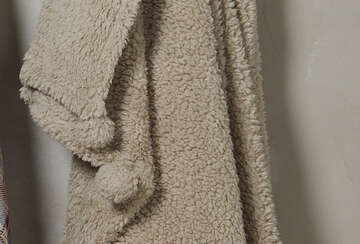 Cosy Pom Pom Throw in Linen with soft tactile fabric and charming pom poms, available at Source for the Goose in Devon