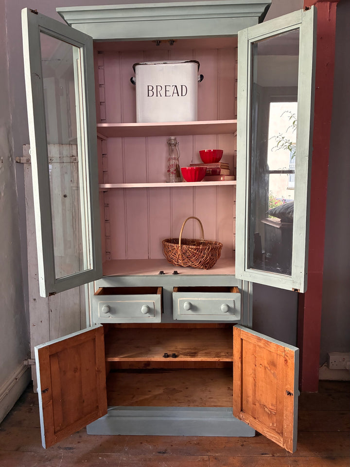 Duck Egg Blue Glazed Kitchen Dresser with glass doors and pale pink interior showcasing shelves and storage.