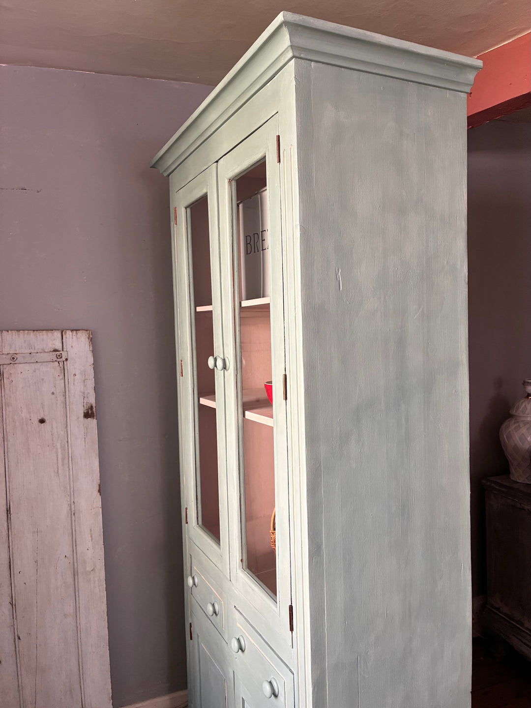 Duck Egg Blue Glazed Kitchen Dresser with glazed cupboard and pale pink interior shelves.