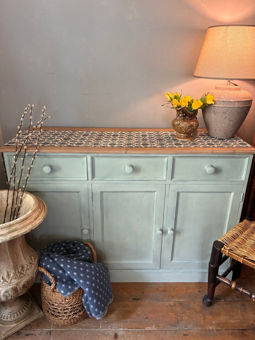 Duck Egg Painted Sideboard with Wooden Top displayed in a cozy room with decorative items.