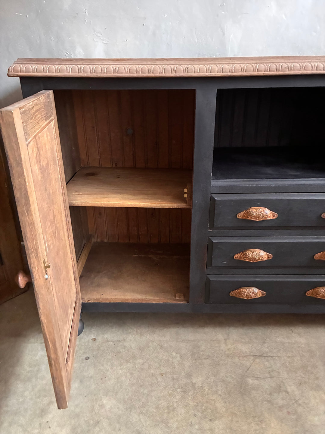 Interior view of Deep Black Oak Sideboard - Hand Painted showcasing spacious shelves and drawers.