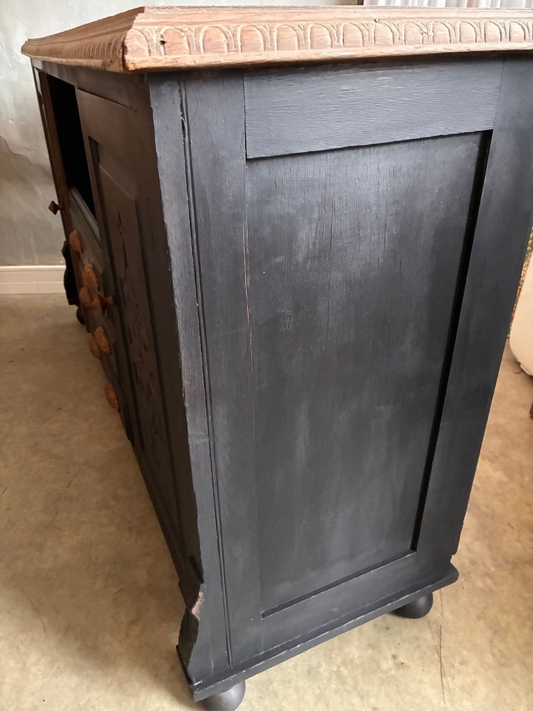 Side view of the Deep Black Oak Sideboard - Hand Painted showcasing its dark ebonised wood and detailed carvings.