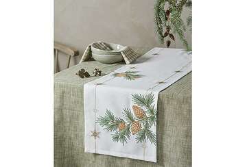 white table runner with embroidered larch design
